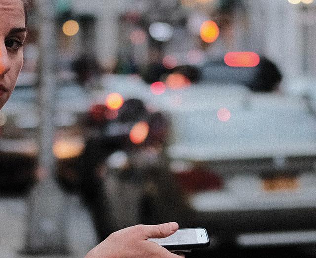 photo of a person in a street with their phone